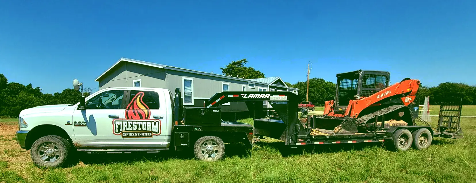 Firestorm Septics & Shelters White 3/4 ton truck & excavator on grassy rural land