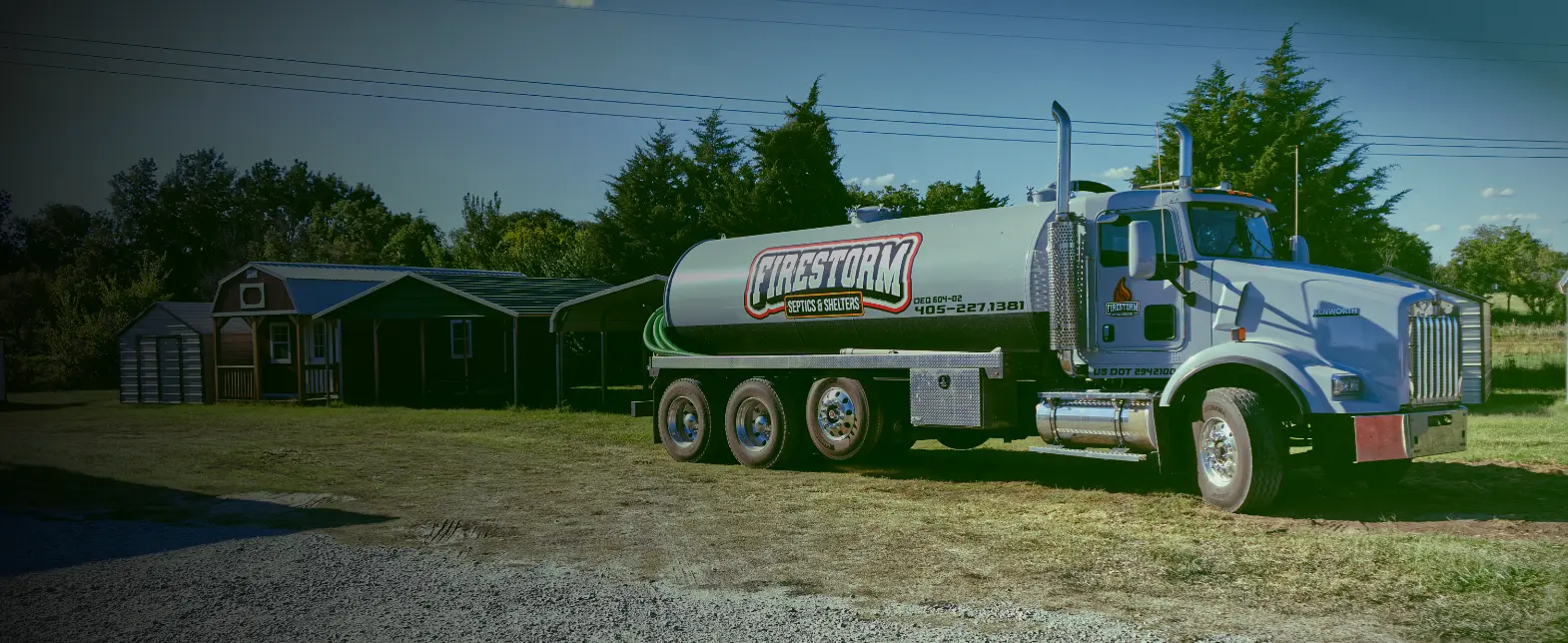 Firestorm Septics & Shelters pump truck on grass.